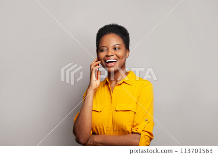 Attractive woman talking by phone on grey banner background 113701563