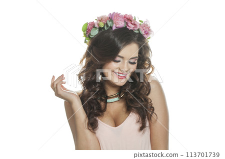 Happy brunette woman with fresh flower on her head. Spring, cosmetic, beauty Happy brunette woman with fresh flower on her head. Spring, cosmetic, beauty 113701739