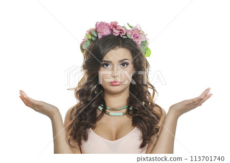 Shocked female model in floral summer wreath on her hair. Young woman with clean skin Shocked female model in floral summer wreath on her hair. Young woman with clean skin 113701740