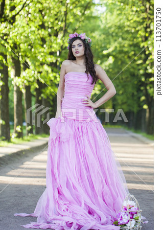 Lovely fashion model woman with healthy hair and natural makeup wearing pink dress  113701750