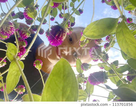 Cute child girl with flower against sky, summer portrait 113701856