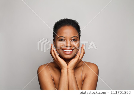 Cheerful wellness model woman with dark shiny skin and cute smile close-up portrait. Cheerful wellness model woman with dark shiny skin and cute smile close-up portrait. 113701893