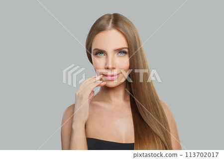 Cute fashion model woman with long healthy hairstyle, fresh shiny skin and makeup 113702017
