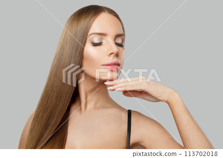 Young adult glamorous woman fashion model with long straight healthy hair and makeup posing  113702018