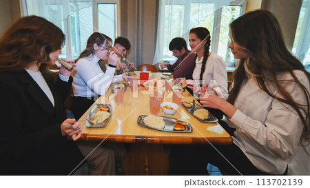 Children eating in the school cafeteria. 113702139