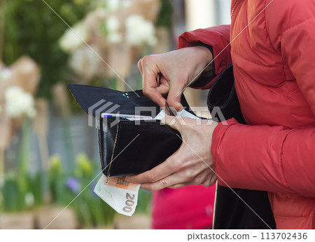 Payment cash for goods at the outdoor market, close-up 113702436
