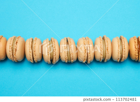 Chocolate macarons on a blue background, dessert Chocolate macarons on a blue background, dessert 113702481