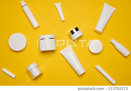 Various types of white plastic packaging, bottle, jar, tube on a yellow background. Container for cosmetics Various types of white plastic packaging, bottle, jar, tube on a yellow background. Container for cosmetics 113702573