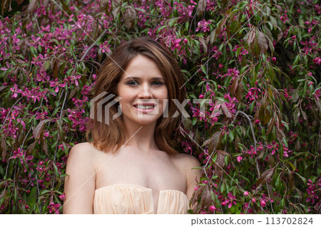 Joyful healthy woman posing outdoor in spring park, closeup portrait 113702824
