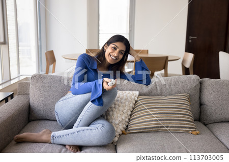 Cheerful attractive young 20s Indian girl watching movie Cheerful attractive young 20s Indian girl watching movie 113703005
