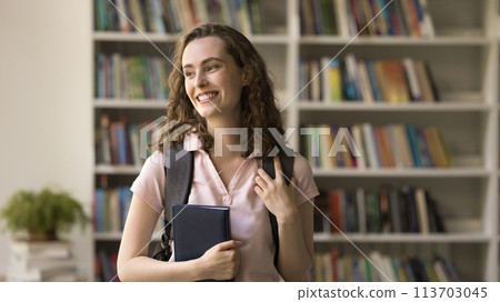 Pensive student girl staring away posing in library Pensive student girl staring away posing in library 113703045