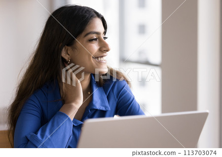 Happy Indian freelance worker girl sitting at laptop 113703074