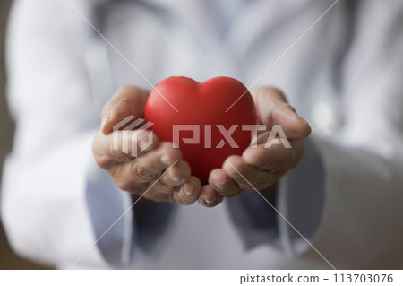 Cardiologist holding heart as symbol of cardiology branch and medicare 113703076