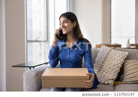 Cheerful satisfied young Indian consumer woman holding paper cardboard box Cheerful satisfied young Indian consumer woman holding paper cardboard box 113703147