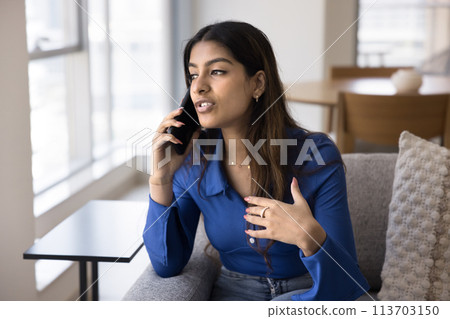 Beautiful Indian young woman making telephone call from home 113703150