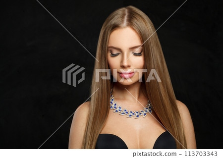 Glamorous woman with makeup wearing jewelry necklace with sapphire and diamond on black background 113703343