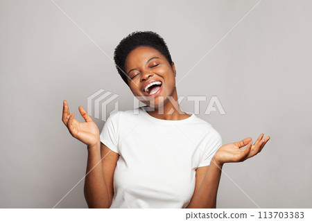 Cheerful successful woman smiling and having fun against studio wall banner background Cheerful successful woman smiling and having fun against studio wall banner background 113703383