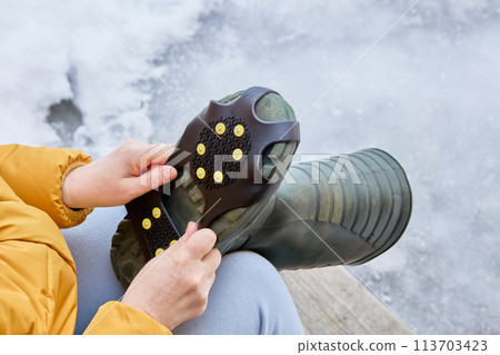 Crampons on rubber pad, ice grips for footwear, over boot attached traction cleats, 10 anti slip spikes. 113703423