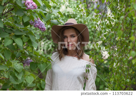 Lovely lady female model in spring leaves background 113703622