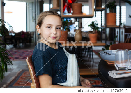 Cute girl enjoying dinner at the restaurant Cute girl enjoying dinner at the restaurant 113703641