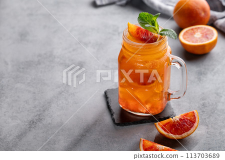 Freshly squeezed blood orange juice with ice, mint and a slice of fruit in a jar Freshly squeezed blood orange juice with ice, mint and a slice of fruit in a jar 113703689