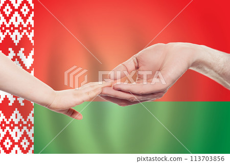Belarussian baby and parent hands on the background of flag of Belarus. Belarussian baby and parent hands on the background of flag of Belarus. 113703856