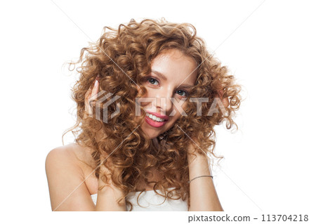 Redhead young woman with natural make-up, clear fresh skin and wavy hairstyle on white background 113704218