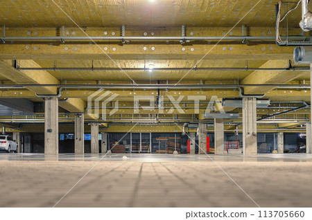 Empty underground parking lot, thermal and acoustic insulation on the ceiling. 113705660