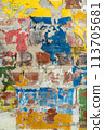 Multi-layered abstract background of various colors of painting and graffiti on a brick wall. 113705681