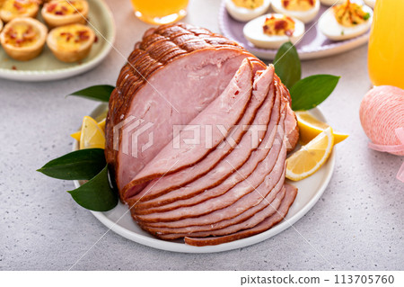 Traditional Easter ham on the table served with brunch Traditional Easter ham on the table served with brunch 113705760