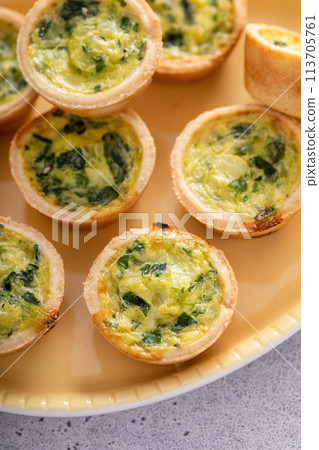 Mini quiches with spinach for Easter brunch Mini quiches with spinach for Easter brunch 113705761