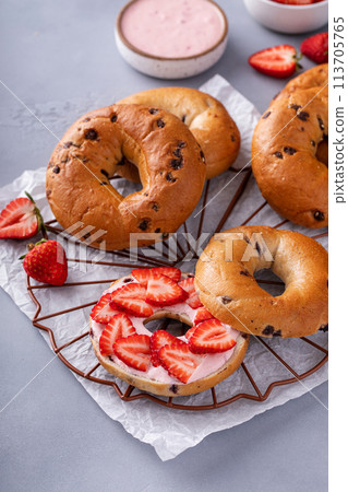 Variety of bagels served with strawberry cream chees and fresh berries 113705765