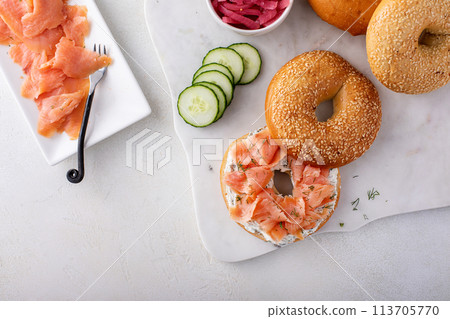 Freshly baked bagels served with dill cream cheese and salmon Freshly baked bagels served with dill cream cheese and salmon 113705770