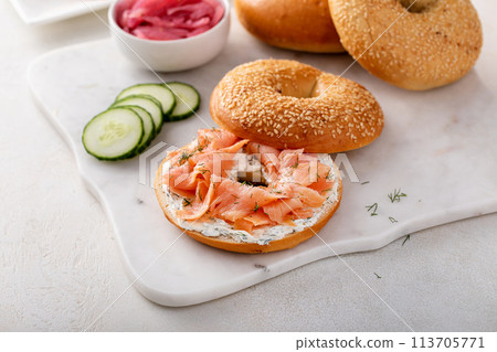 Freshly baked bagels served with dill cream cheese and salmon 113705771
