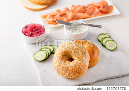 Freshly baked bagels served with dill cream cheese and salmon 113705778