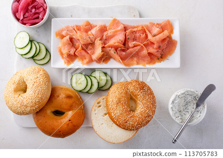 Freshly baked bagels served with dill cream cheese and salmon 113705783