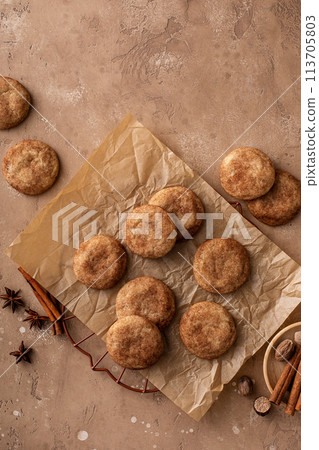 Cinnamon cookies on a parchment paper with milk Cinnamon cookies on a parchment paper with milk 113705803