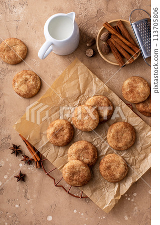 Cinnamon cookies on a parchment paper with milk Cinnamon cookies on a parchment paper with milk 113705806