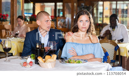 Unhappy couple quarreling during dinner at restaurant Unhappy couple quarreling during dinner at restaurant 113708054