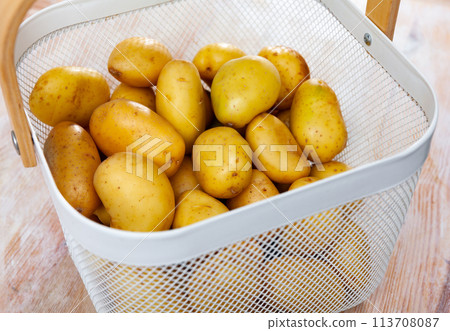 Image of freshly washed potatoes in a bucket Image of freshly washed potatoes in a bucket 113708087