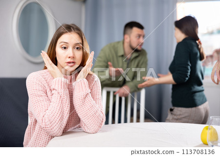 Woman waiting for family couple stop quarreling Woman waiting for family couple stop quarreling 113708136