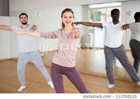 Woman and men dancing in fitness studio 113708220