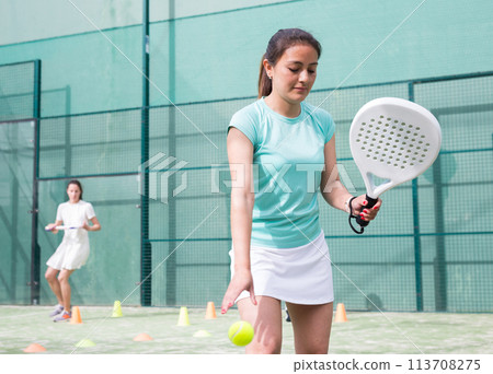 Portrait of young woman during paddle training Portrait of young woman during paddle training 113708275