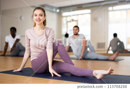 Woman and men practising yoga poses 113708288