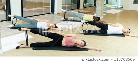 People exercising with pilates ring at class People exercising with pilates ring at class 113708509