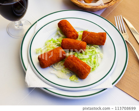 Spanish flamenquines, breaded pork loin rolled with serrano ham Spanish flamenquines, breaded pork loin rolled with serrano ham 113708699