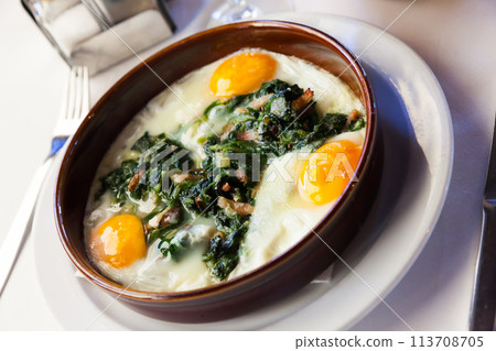 Fried eggs with spinach, ham, raisins 113708705