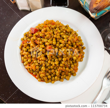 Plate of stewed beans with ham on table Plate of stewed beans with ham on table 113708734