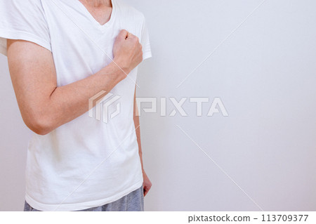 Man putting his fist on his chest 113709377