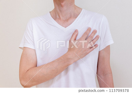Man placing hand on left chest Man placing hand on left chest 113709378